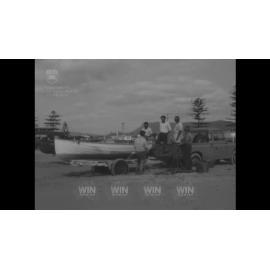 Men preparing a boat and nets for fishing