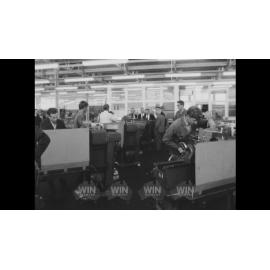 Eric Ramsay and a naval officer tour a turning workshop