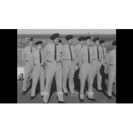 A Navy Captain inspects a group of soldiers