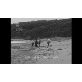 A deceased person is removed from a beach