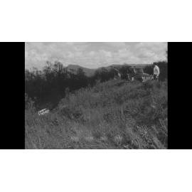 A mini has gone off the road and down an embankment