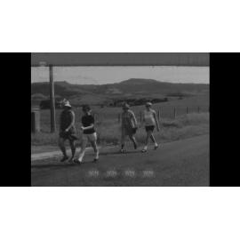 Young people walking along a rural road