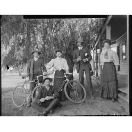Group portrait of three men and two women with bicycles